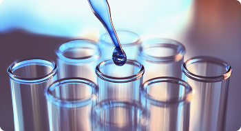 Pipette adding liquid to test tubes, essential for cancer resources research.